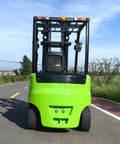 Heavy Duty Electric Forklift With LED Light And Safe Driving Axle for outdoor site, green chassis facing road