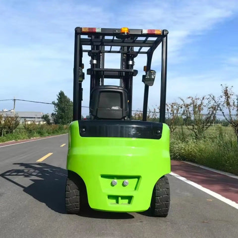 Heavy Duty Electric Forklift With LED Light And Safe Driving Axle for outdoor site, green chassis facing road