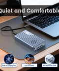 Thunderbolt 5 M.2 NVMe SSD Enclosure With 80Gbps Knockout Speed and Heavy Duty Cooling Fan next to a laptop on a desk.