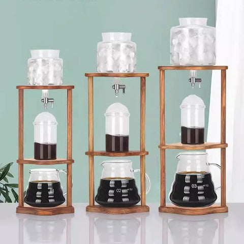 Portable Cold Brew Drip Tower Iced Coffee Maker Straight Up Smooth with glass jars and wooden stand for cold coffee brewing.