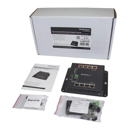Rock Solid Eight Port Gigabit PoE Switch With Four Powered Ports And One Twenty Watt Budget industrial switch components laid out with manual and magnet kit.