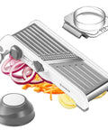 Front view: Hesheein 24-in-1 mandoline slicer with waffle fry blade; white/silver body, adjustable thickness.