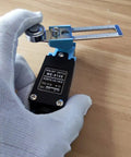 Gloved hand holding Limit Switch Travel Switch With Adjustable Roller Lever Arm for CNC Mill Laser Plasma Router NC NO DPDT
