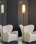 Modern Tall LED Floor Lamp With Linen Shade And Black Iron Pole, Perfect For Living Room, shown on and off beside a chair.