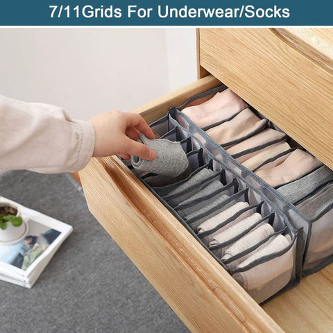 Person organizing clothes in stackable wardrobe drawer organizer with 7/11 grids inside wooden drawer, space saver for socks and underwear.