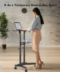 Woman using On Wheels Portable Standing Laptop Desk With Height Adjustable Sit Stand 0 To 40 Degree Tilt Rolling Cart in home office