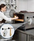 Six Pack Magnetic Hooks With Neodymium Magnets Strong Hold For Office Bathroom Kitchen And Fridge Great For Towels Grills Mugs And Gear On Cruise Ships Or At Home Garage Organization Three Inch Long Mini Hangers With One Point Seven Pound Capacity holding an oven mitt and spatula on a kitchen oven