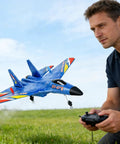 Man flying Su-27 Inspired RC Fighter Jet For Adults And Beginners, durable lightweight foam airplane outdoors, with a remote control in hand