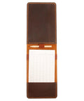 Open Personalized Leather Golf Yardage Book Holder and Scorecard Cover for Golfers with pencil and paper inside.