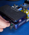 4 In 1 Guitar Effects Pedal With Active Wah, Expression, And Dual Volume Modes in use on blue surface