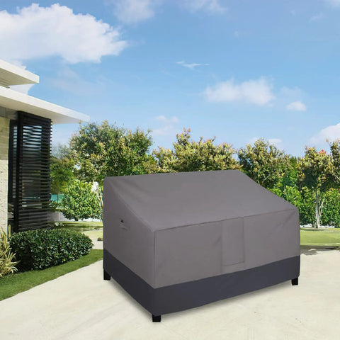 Heavy Duty 2 Seater Outdoor Loveseat Cover Waterproof Windproof With Air Vent 58 Inch Wide 32.5 Inch Deep 31 Inch High Gray Dark Gray Patio Furniture Sofa Cover Built Tough covering a patio sofa on a sunny day.
