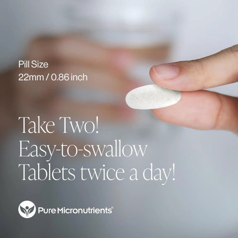 Person holding Complete Bone Health Calcium Supplement tablet, 22mm size, emphasizing daily intake recommendation.