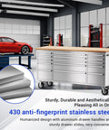 72 Inch Mobile Tool Chest With 15 Drawers And An 18 Inch Deep Wood Top in a garage setting, showing stainless steel finish and casters.