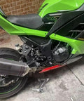 Upgrade Your Ride With These Heavy Duty Exhaust Hanger Muffler Bracket Kit Made For Kawasaki Ninja250 And Ninja300 Models From 2013 To 2018 Featuring Thick Iron Build Superior Durability Plus That Sweet Black Finish Youve Been Searching For Today. black iron exhaust hanger bracket kit installed on Kawasaki Ninja 300, side view