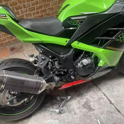 Upgrade Your Ride With These Heavy Duty Exhaust Hanger Muffler Bracket Kit Made For Kawasaki Ninja250 And Ninja300 Models From 2013 To 2018 Featuring Thick Iron Build Superior Durability Plus That Sweet Black Finish Youve Been Searching For Today. black iron exhaust hanger bracket kit installed on Kawasaki Ninja 300, side view