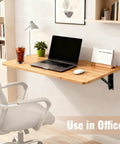 Wall Mounted Folding Table For Garage And Laundry Room Use, Handy Home Wall Desk And Folding Workbench, Space Saver That Handles Up To 100 Lbs, Solid Wall Mount Only, 15.7 By 31.5 Inches, Easy Fold Down Surface with laptop and chair in office setting.