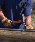 Person using Go To Lineman 26 Ounce Claw Milled Hammer With Fiberglass Handle Heavy Duty For Utility Poles High Visibility