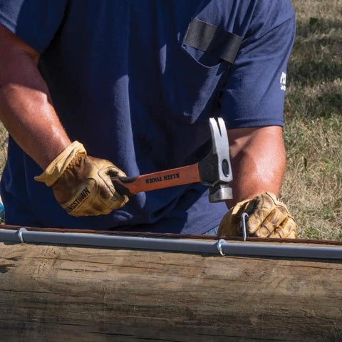 Person using Go To Lineman 26 Ounce Claw Milled Hammer With Fiberglass Handle Heavy Duty For Utility Poles High Visibility