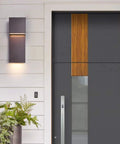 Sleek Outdoor Indoor LED Wall Sconce With Two Lights, 17W Total, Bronze Finish installed beside front door on porch