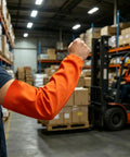 No Sweat Flame Resistant Welding Sleeves With Adjustable Cotton Fit shielding arm in vivid orange color in warehouse.
