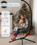 Cozy Outdoor Egg Chair With Stand, Wicker Hanging Swing Chair With Cushion, 350 Lb Weight Capacity For Patio Garden Balcony And Bedroom, Tool Free Assembly In Under 30 Minutes, Dark Grey showing a mother reading to child during holidays.