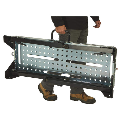 Man carrying folded Pro Grade Height Adjustable Welding Table With 1000-Lb Capacity, Heavy Duty Metal Work Bench For Welding