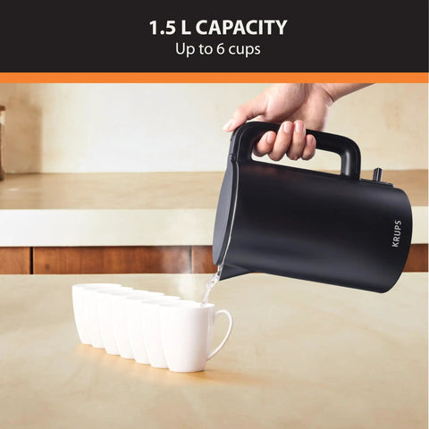 1.5L Cordless Electric Kettle With Cool Touch Exterior And Stainless Steel Interior pours into six white cups