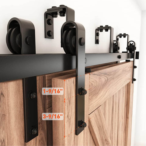 9 Foot Double Track Bypass Sliding Barn Door Hardware Kit For Two Doors Low Ceiling Ready Easy Install J Shape Hanger Heavy Duty Quarter Inch Carbon Steel Coated Black Rust Resistant Fits 54 Inch Wide Door Panel Quiet Smooth Operation installed on wooden door panel showing J shape hangers and steel rails.