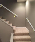Pair Of Slick Clear Acrylic Interior Stair Handrails Mounted To Rust Proof Gold Brackets Heavy Duty Safety Grab Bars Anti Skid Top Shelf Quality For Modern Home Reno installed on carpeted stairs.