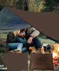 Campers using Beefy Heavy Duty Survival Blanket With Reflective Tarp For Camping And Outdoors Waterproof Sandproof Thermal Emergency Blanket Ultra Portable Foldable In Compact Carry Bag For Easy Stowaway 60x83 Inches by a campfire.
