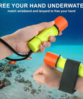 Hands holding Beast 400 Lumen Underwater Dive Light for scuba diving, showing wristband and lanyard in ocean scene.