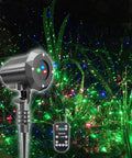 Garden Laser Christmas Lights Projector With Moving Firefly Stars, Red Green Blue Color Combo, remote control visible in garden