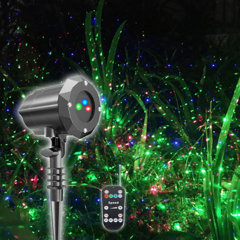 Garden Laser Christmas Lights Projector With Moving Firefly Stars, Red Green Blue Color Combo, remote control visible in garden