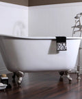 Vintage claw foot tub in polished chrome finish next to faucet set, showcasing elegant bathroom design. Focus on clawfoot style.