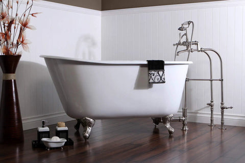 Vintage claw foot tub in polished chrome finish next to faucet set, showcasing elegant bathroom design. Focus on clawfoot style.