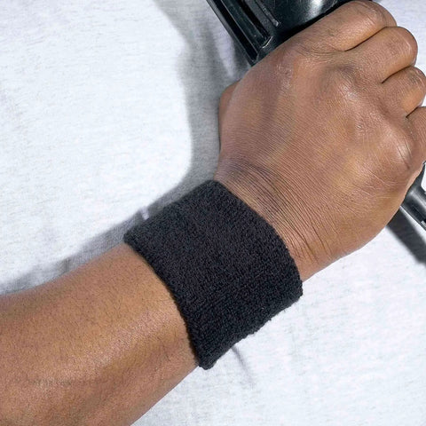 Black Terry Cloth Wrist Sweatbands For Adults, Thick Absorbent Cotton, Unisex Pair, on wrist holding equipment, close-up view