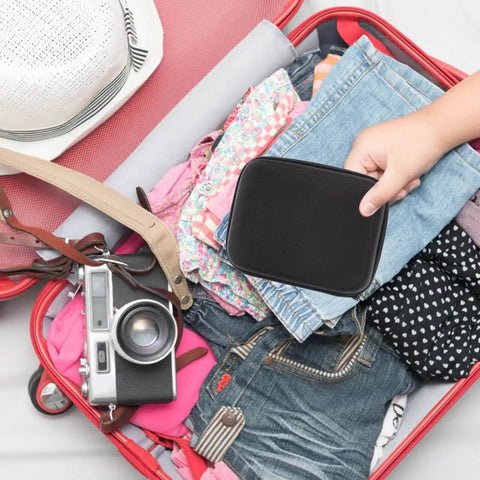 Heavy Duty Hard Shell Tech Carry Pouch For Chargers Power Banks Cables And Earbuds With Water Resistant Cover in a suitcase.