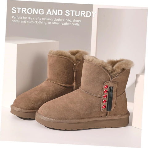 Side view brown suede fur-lined ankle boots with red rivet studs on the side and a black rivet tool