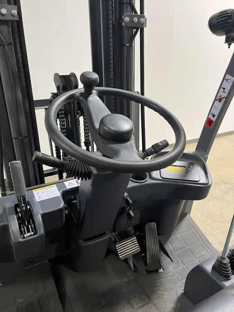 4 Wheel Electric Forklift Truck With 6600 Lb Capacity control panel, steering wheel, and pedals for smooth operation.