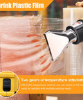 Cordless Rechargeable Hot Air Gun With Two Speed Temp Controls And Four Nozzle Set For Paint Stripping Shrink Wrap Fitting Thawing Fast Heating Handheld Electric Tool used on shrink plastic film, showcasing adjustable temperature settings.