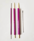 Versatile Fabric Tube Turner Set For DIY Sewing With Three Cylinder Sizes One Sixteenth Inch Three Eighths Inch And One Half Inch Plus Ball Point Bodkin Drawstring Threader For Easy Tube Turning And A Handy Must Have Tool Bundle showing three purple cylinders and metal bodkin on white background.