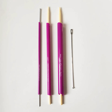 Versatile Fabric Tube Turner Set For DIY Sewing With Three Cylinder Sizes One Sixteenth Inch Three Eighths Inch And One Half Inch Plus Ball Point Bodkin Drawstring Threader For Easy Tube Turning And A Handy Must Have Tool Bundle showing three purple cylinders and metal bodkin on white background.