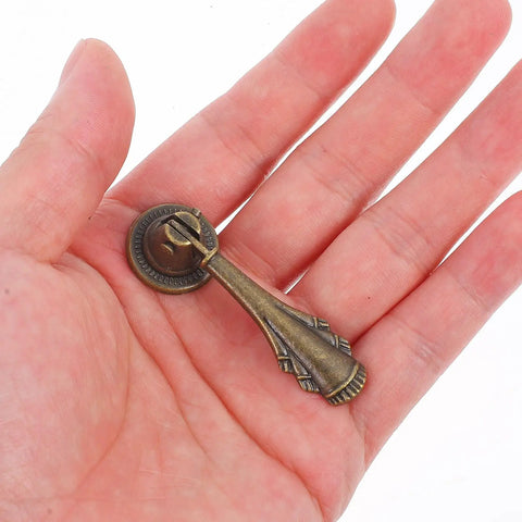 10 Pack Dope Vintage Style Zinc Alloy Drawer Pulls With Single Hole Design in hand, showing light brown finish detail