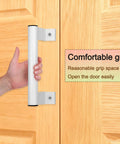 Person gripping 8 Inch White Aluminum Sliding Door Handle installed on wooden door with text 'Comfortable grip'. Two Pack 8 Inch Aluminum Sliding Door Handle Set In White, White Alloy Sliding Door Pull Handles For Patio And Bathroom, Comfort Grip, Easy Installation, Durable Aluminum Alloy Construction With Polished Finish, Smooth Sliding Operation.