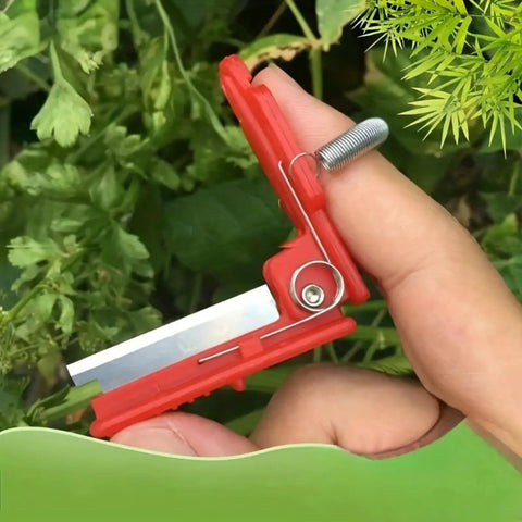 Close-up of a red Thumb Knife and Pruning Shears for Leaf Trimming and Fruit Picking in the Garden, showing precision stainless steel blades.