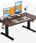 Top Notch ErGear Low Height Adjustable Electric Standing Desk 48 X 24 Inches For Kids with dual monitors and accessories.