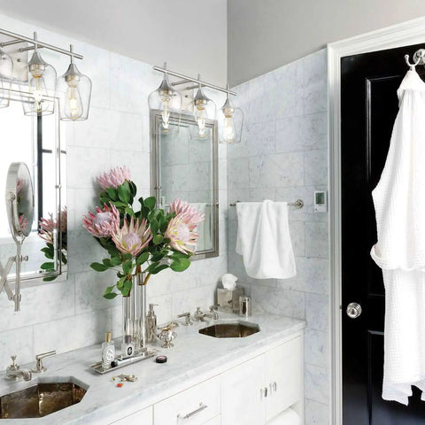 Three Light Vanity Light Fixture Over Mirror in Brushed Nickel With Clear Glass Wine Glass Shades in modern bathroom.