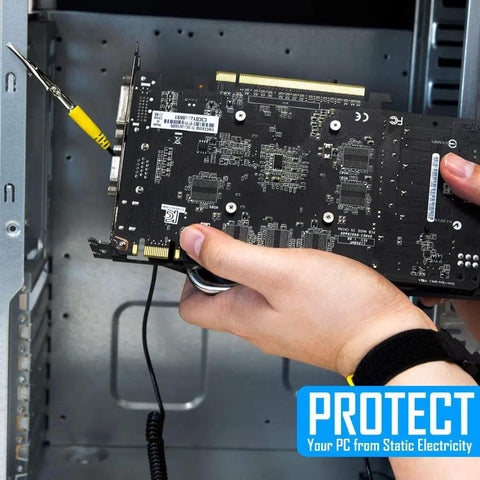 Person using adjustable ESD wrist strap with grounding cord while holding a graphics card for PC building and electronics repair.