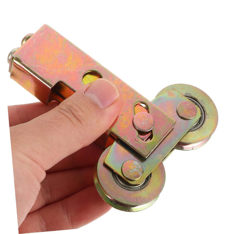 Heavy Duty Steel Roller Pulleys For Sliding Doors And Windows, held in hand, showing dual wheels and metal construction
