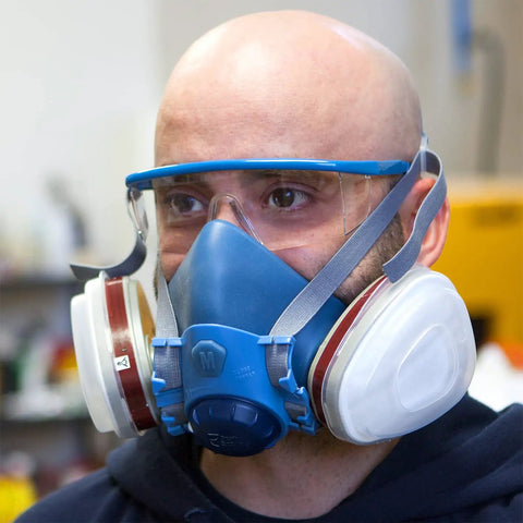 Man wearing Pro Grade Half Mask Respirator With Reusable Filters And Safety Glasses For Dust Pollen And Organic Vapor Protection